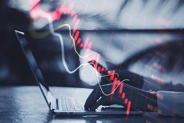 economy recession crisis concept with going down digital red financial chart candlestick graphs man hands typing modern laptop outdoors double exposure 670147 31233 2158323971